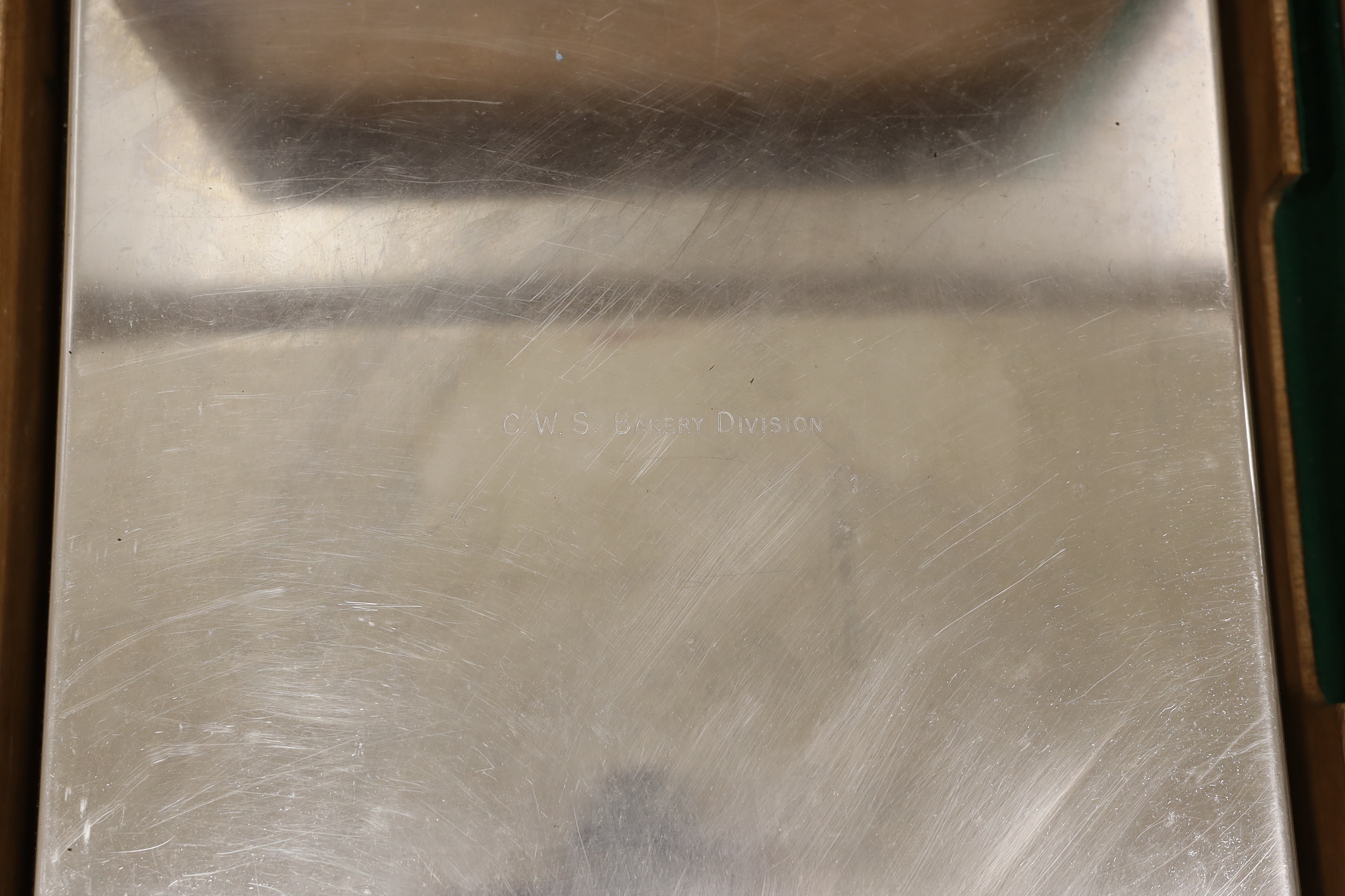 A stainless steel wedding cake stand, in original wooden box, marked C.W.S Bakery Division